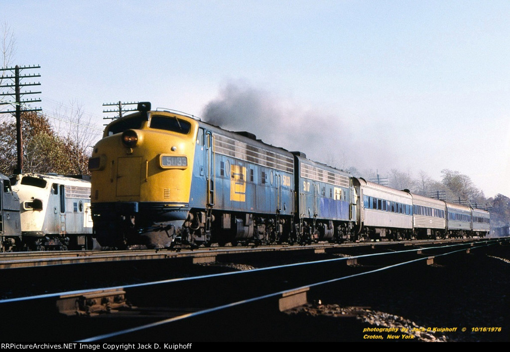 PC, Penn Central FL9s, 5033-5017, are northbound on the east shore of the Hudson River at Croton-on-Hudson, New York. October 16, 1976. 